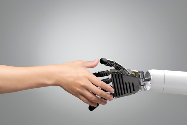 Human hand shaking hands with a robotic hand, symbolizing collaboration between humans and robots in modern security systems.