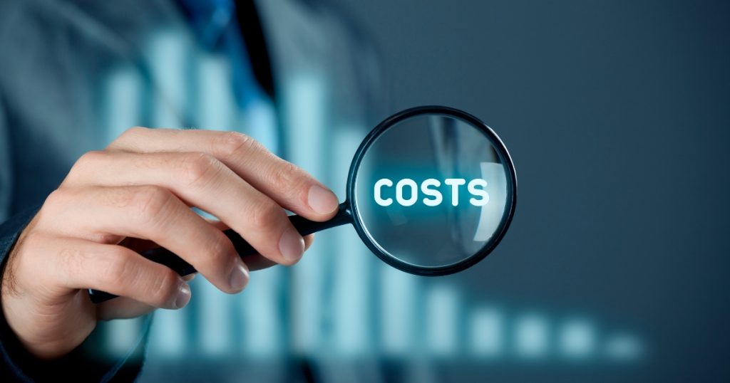 A magnifying glass over the word "COSTS" with a bar graph in the background.